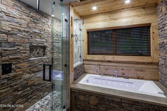 bathroom featuring independent shower and bath