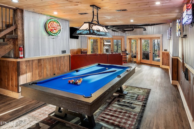 rec room with hardwood / wood-style flooring, wooden walls, wooden ceiling, pool table, and french doors