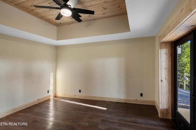 spare room featuring ceiling fan, dark hardwood / wood-style flooring, a high ceiling, and wooden ceiling