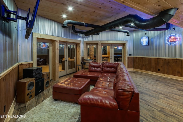 cinema room featuring wooden ceiling, french doors, wooden walls, and hardwood / wood-style flooring