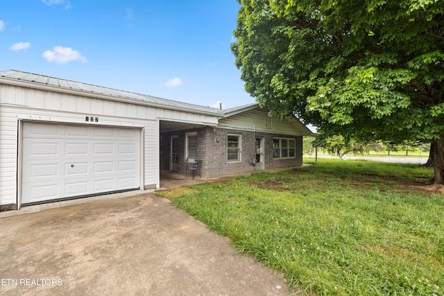 single story home featuring a garage and a front yard