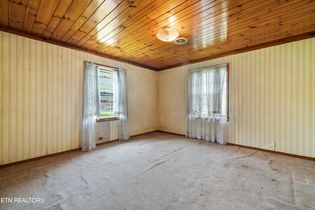 unfurnished room featuring wooden ceiling and carpet