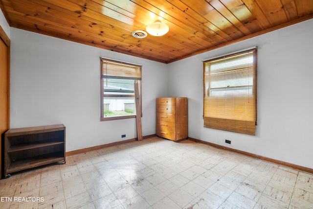 spare room with light tile floors and wood ceiling