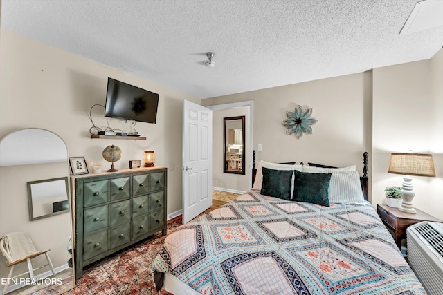 bedroom featuring a textured ceiling and carpet floors