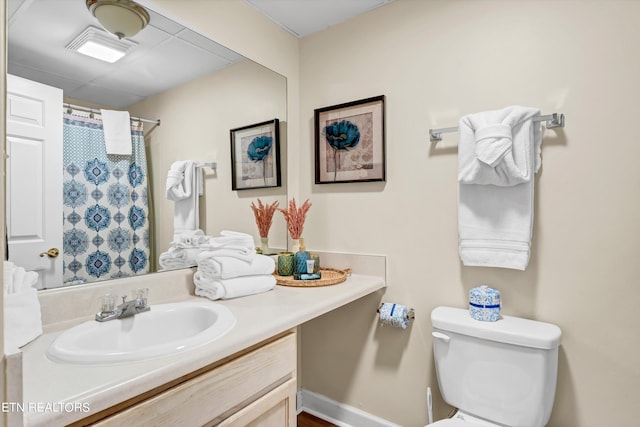 bathroom featuring oversized vanity and toilet