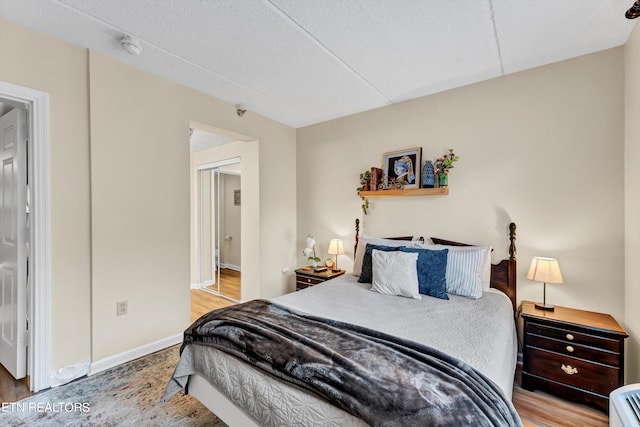 bedroom featuring a textured ceiling and light wood-type flooring