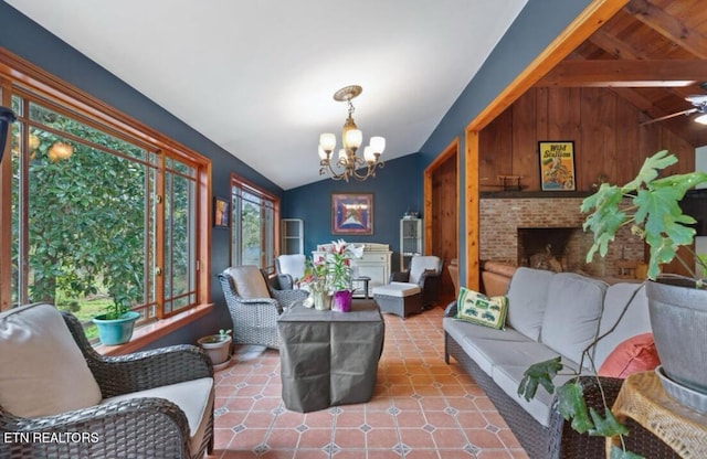 interior space featuring a brick fireplace, lofted ceiling with beams, ceiling fan with notable chandelier, tile floors, and wood walls