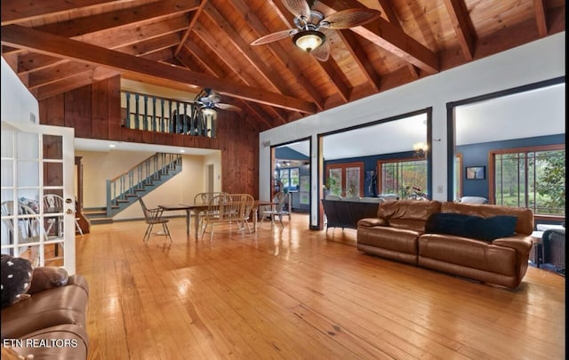 living room with wood ceiling, light hardwood / wood-style floors, beam ceiling, and high vaulted ceiling