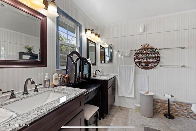 bathroom featuring ornamental molding, double vanity, and tile floors