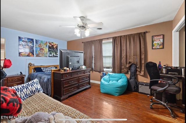 bedroom with dark hardwood / wood-style floors and ceiling fan