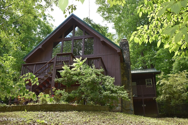 view of side of property with a wooden deck