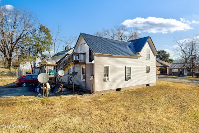 view of side of home with a lawn