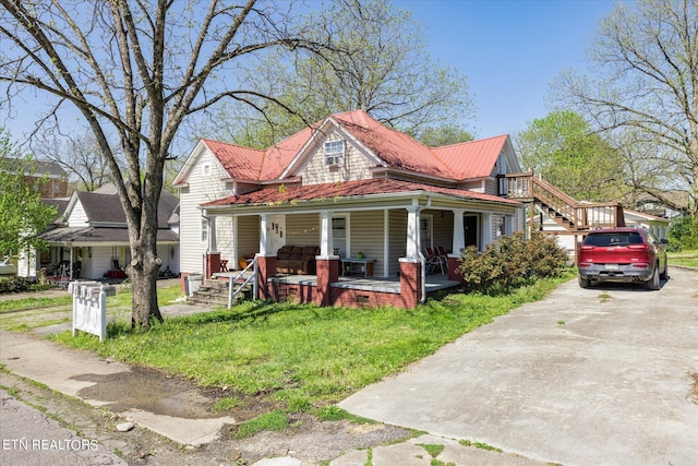 view of front of house with a front lawn, a garage, and a porch