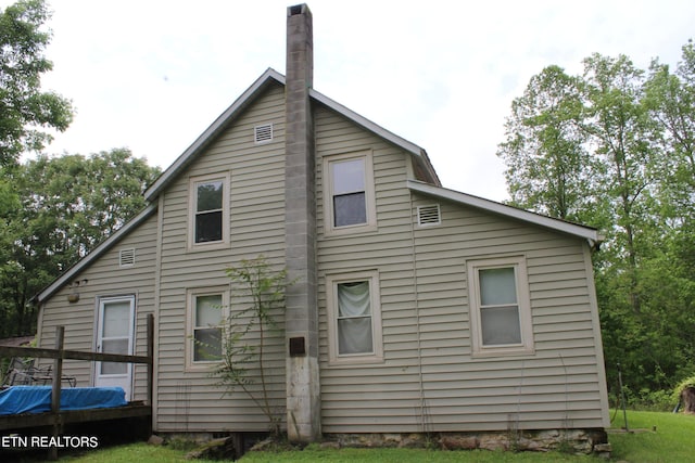 back of property with a wooden deck