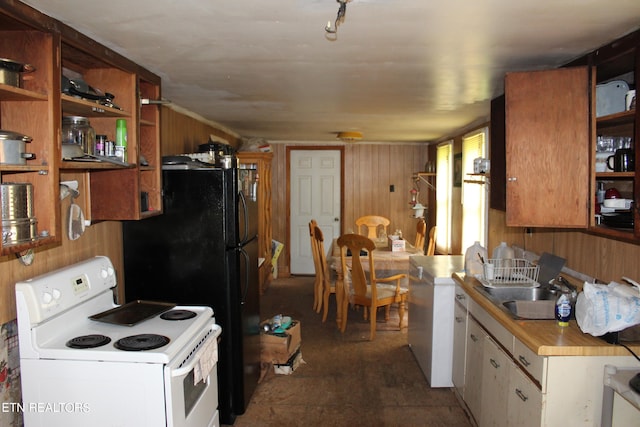 kitchen featuring wood walls, sink, and white range with electric cooktop