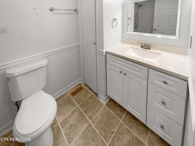 bathroom featuring tile floors, oversized vanity, and toilet