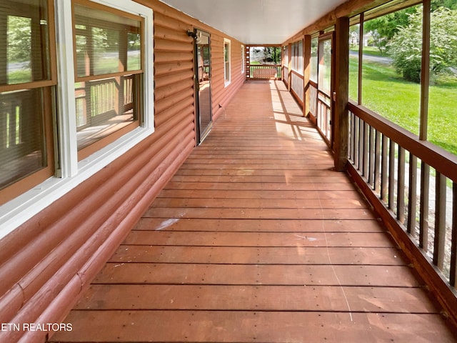 wooden deck featuring a lawn