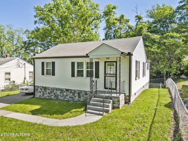 bungalow-style house with a front lawn