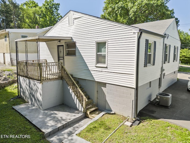 rear view of property featuring central AC unit