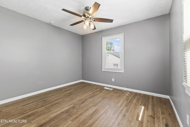 unfurnished room featuring ceiling fan and hardwood / wood-style flooring