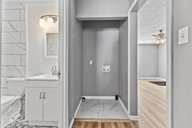 bathroom with ceiling fan, tile flooring, toilet, and vanity