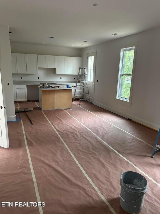 unfurnished living room with concrete floors