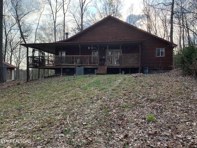 back of property featuring central AC unit and a wooden deck