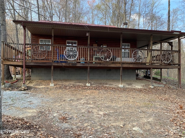 back of house with a wooden deck