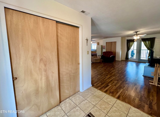 interior space with french doors, ceiling fan, and light tile floors