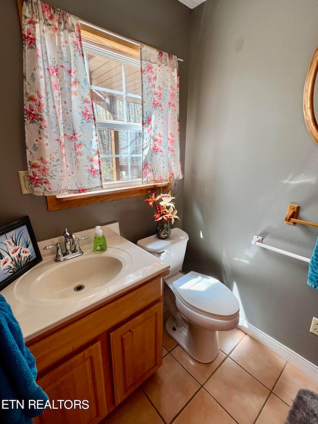 bathroom featuring tile floors, toilet, and vanity