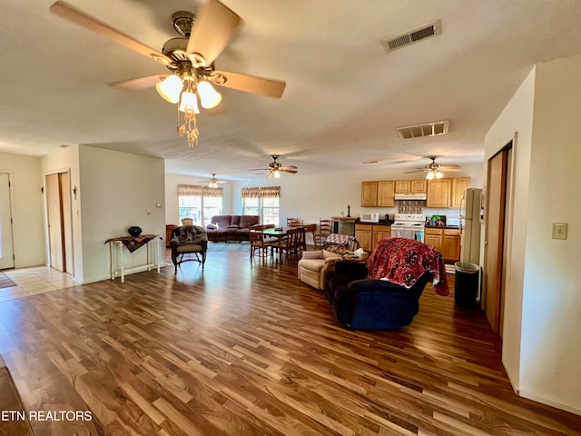 living room featuring ceiling fan and wood-type flooring