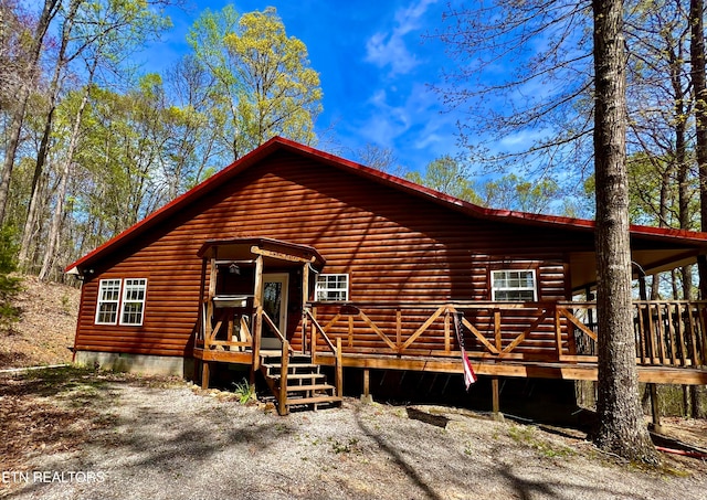 back of house with a wooden deck