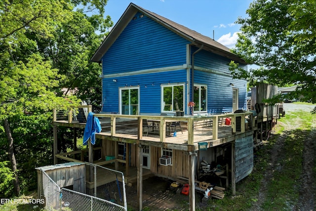 back of house with a deck