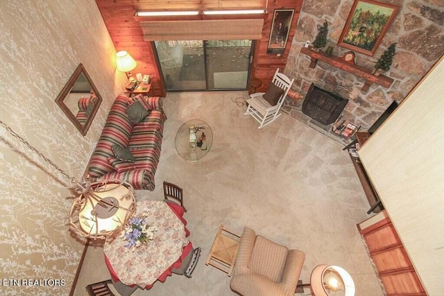 living room with wood walls and a fireplace