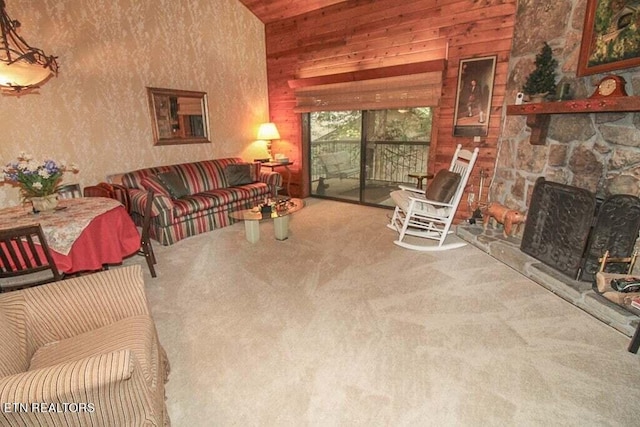 carpeted living room with a stone fireplace and wood walls