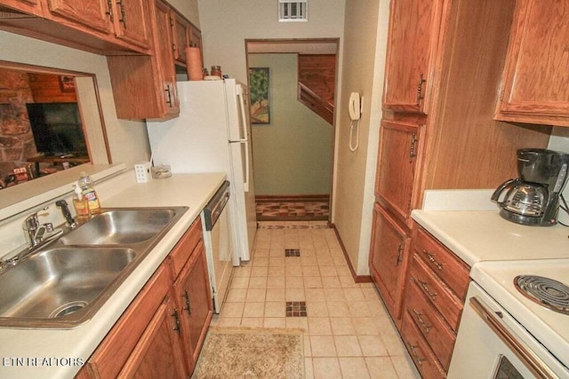 kitchen with sink, stainless steel dishwasher, light tile floors, and range