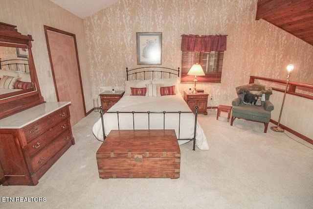 carpeted bedroom featuring vaulted ceiling