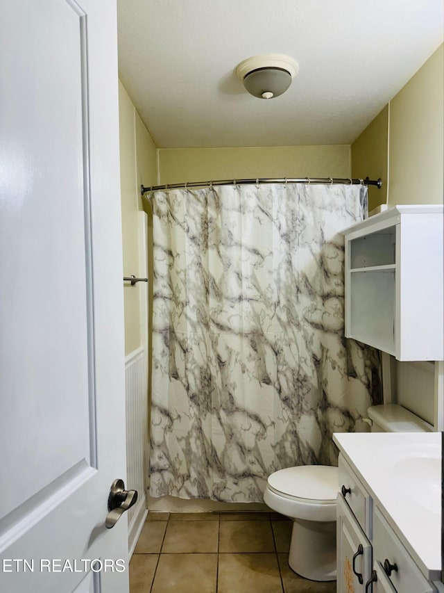 full bathroom featuring toilet, tile patterned flooring, shower / tub combo, and vanity