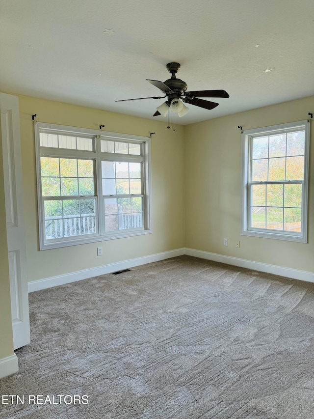 unfurnished room featuring ceiling fan and light carpet