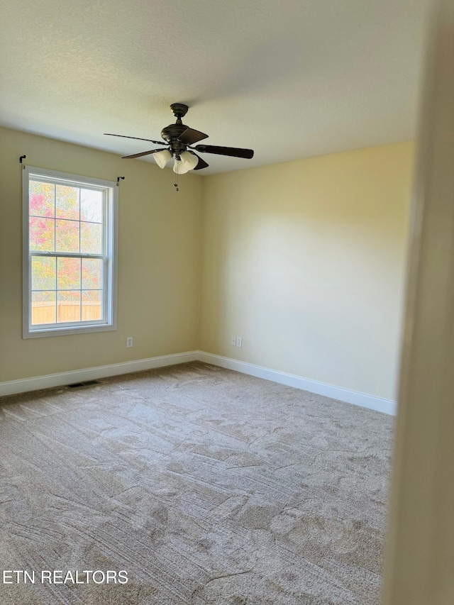 carpeted empty room featuring ceiling fan