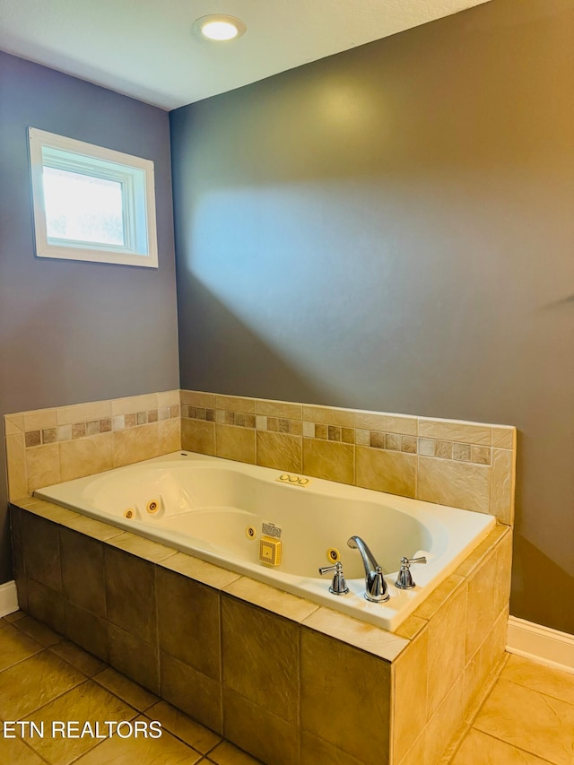 bathroom with tiled bath and tile patterned flooring