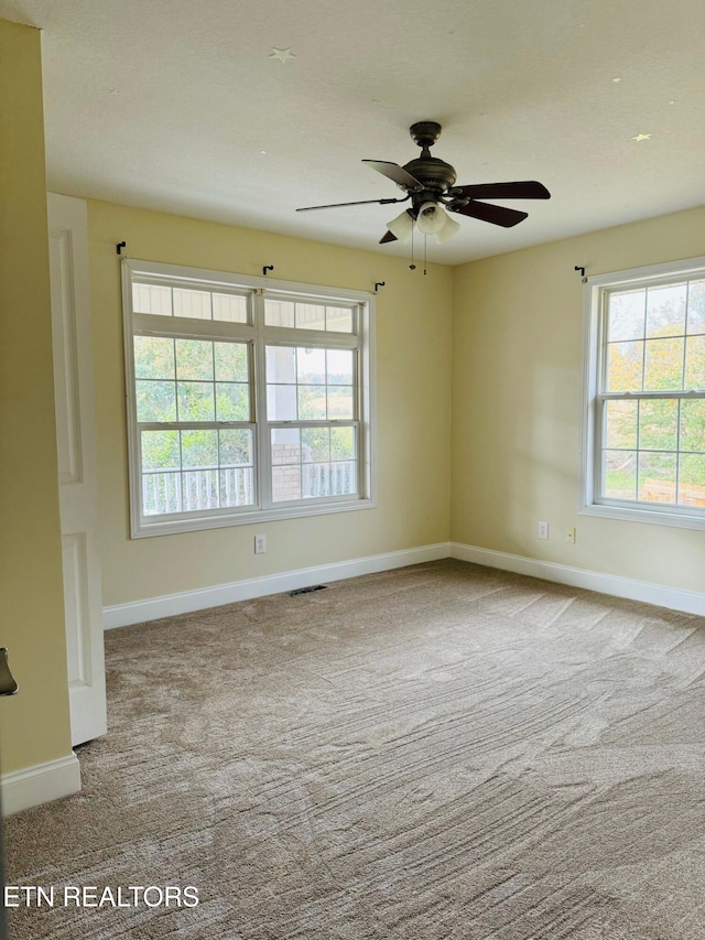 unfurnished room featuring ceiling fan and carpet floors