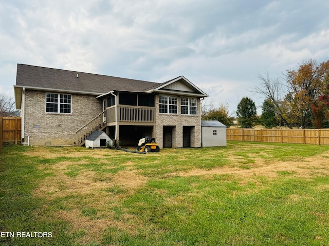 rear view of house featuring a yard and a sunroom