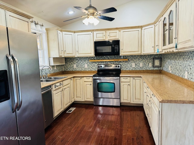 kitchen with ceiling fan, stainless steel appliances, decorative backsplash, dark wood-type flooring, and sink