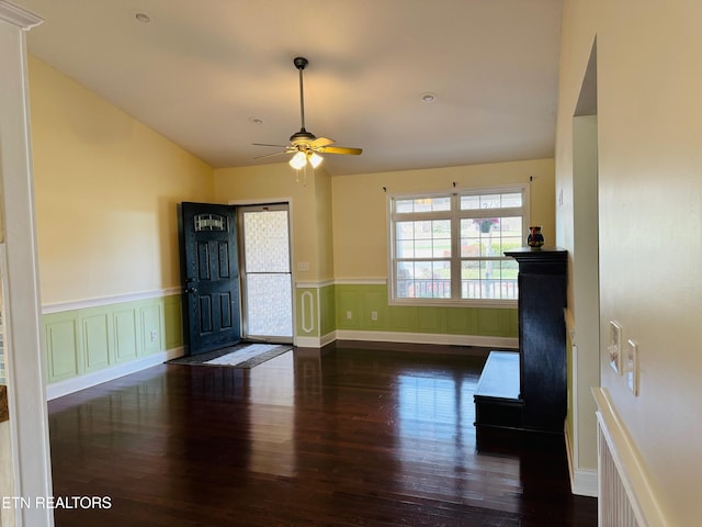 foyer entrance with ceiling fan, dark hardwood / wood-style flooring, and lofted ceiling