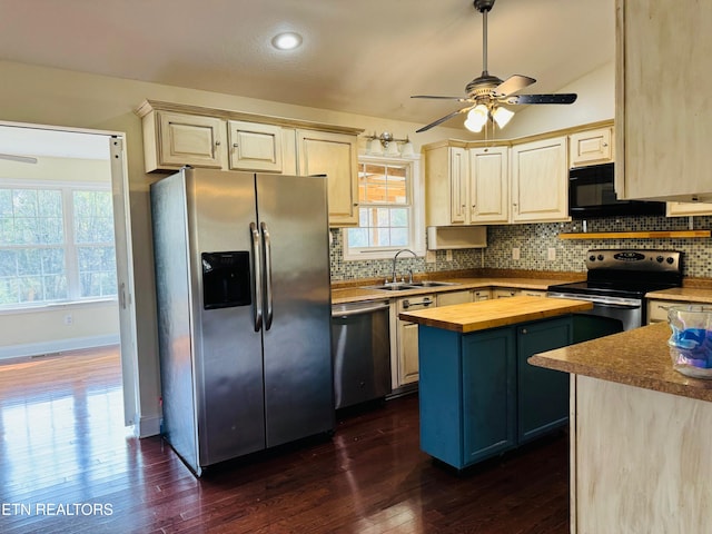 kitchen featuring wooden counters, stainless steel appliances, dark hardwood / wood-style floors, a kitchen island, and sink