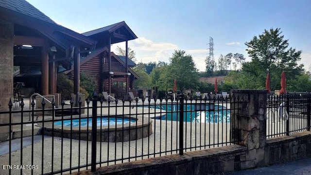 view of pool featuring a hot tub and a patio area