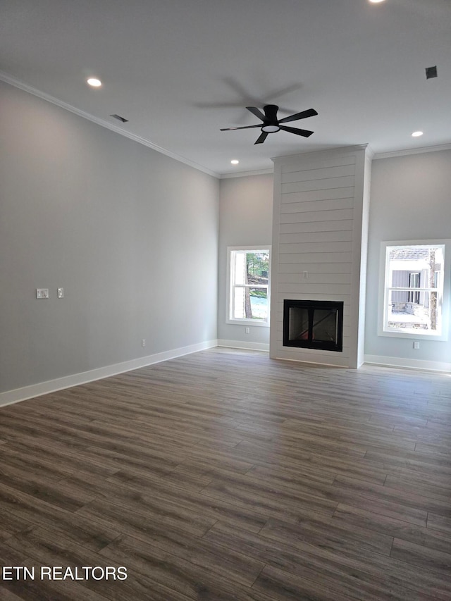 unfurnished living room with a fireplace, dark hardwood / wood-style floors, and crown molding