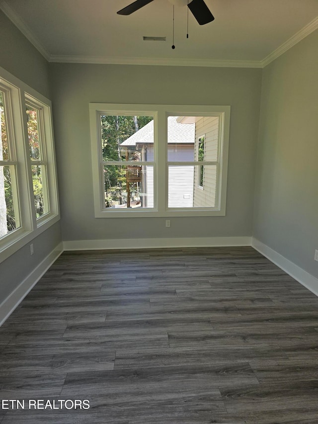 spare room featuring crown molding, ceiling fan, and dark wood-type flooring