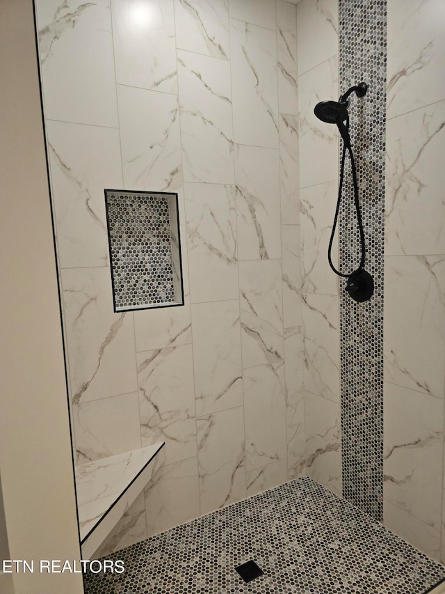 bathroom with a tile shower